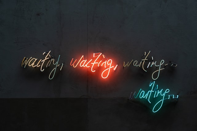 neon signs saying "waiting"